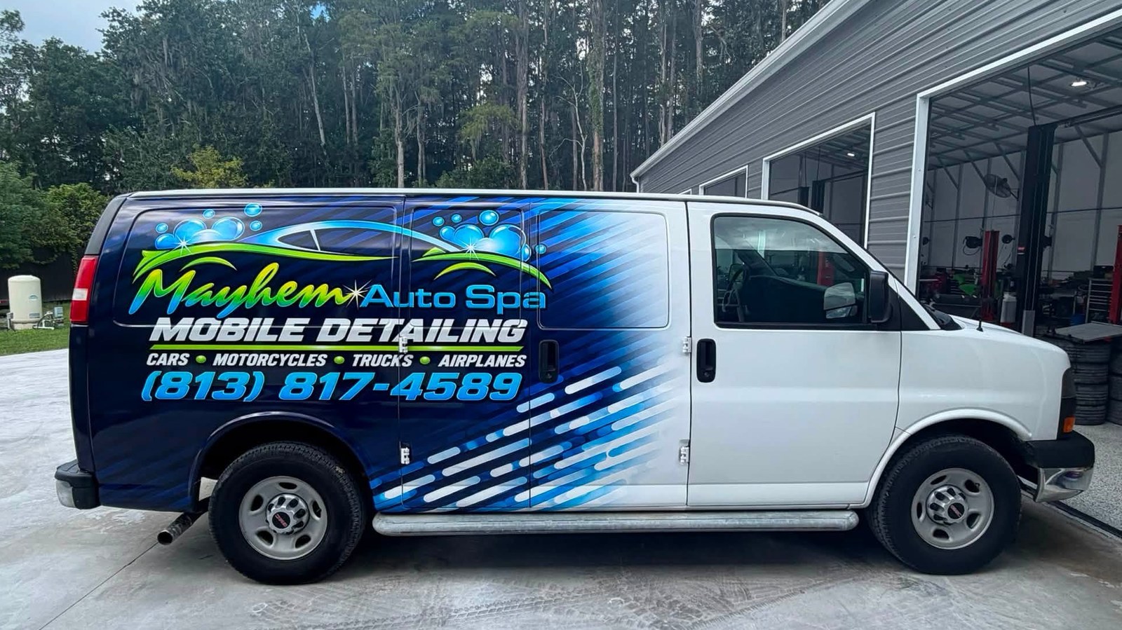 Mayhem Auto Spa mobile detailing van parked outside the shop